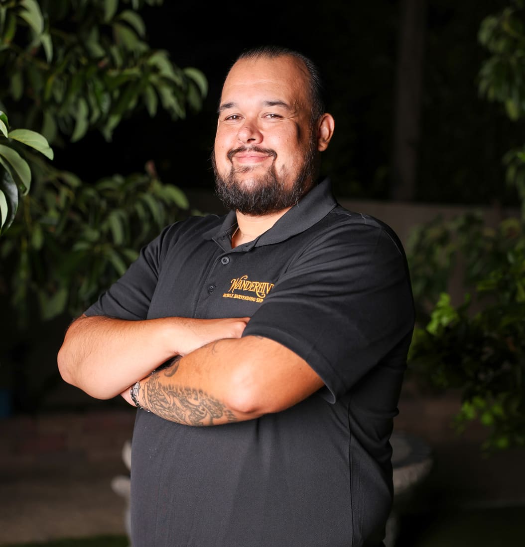 Wanderhive team member smiling with arms crossed
