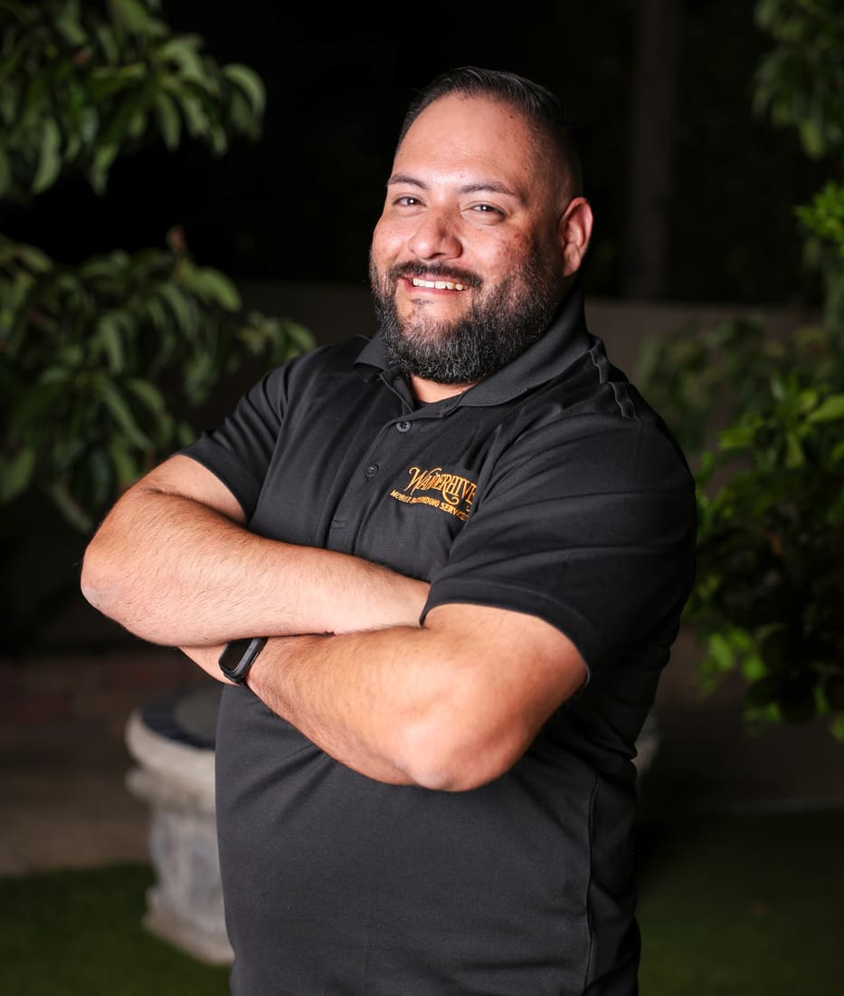 Wanderhive team member smiling with arms crossed
