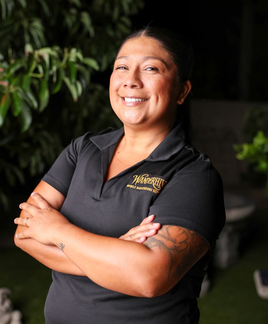 Wanderhive team member smiling with arms crossed