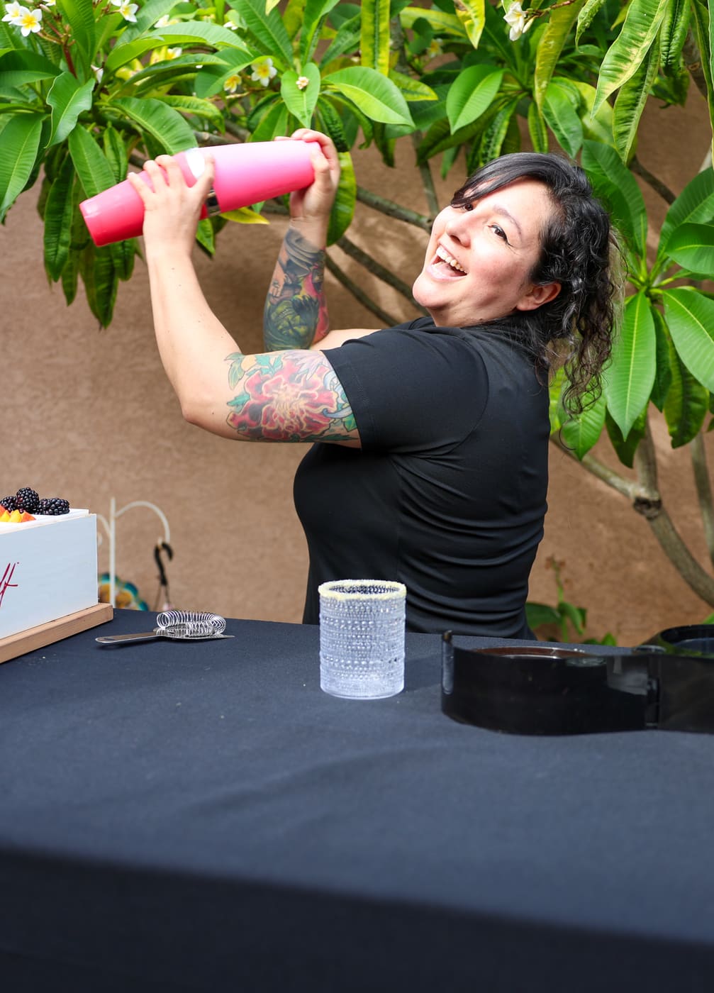 Wanderhive bartender shaking a cocktail at an outdoor bar
